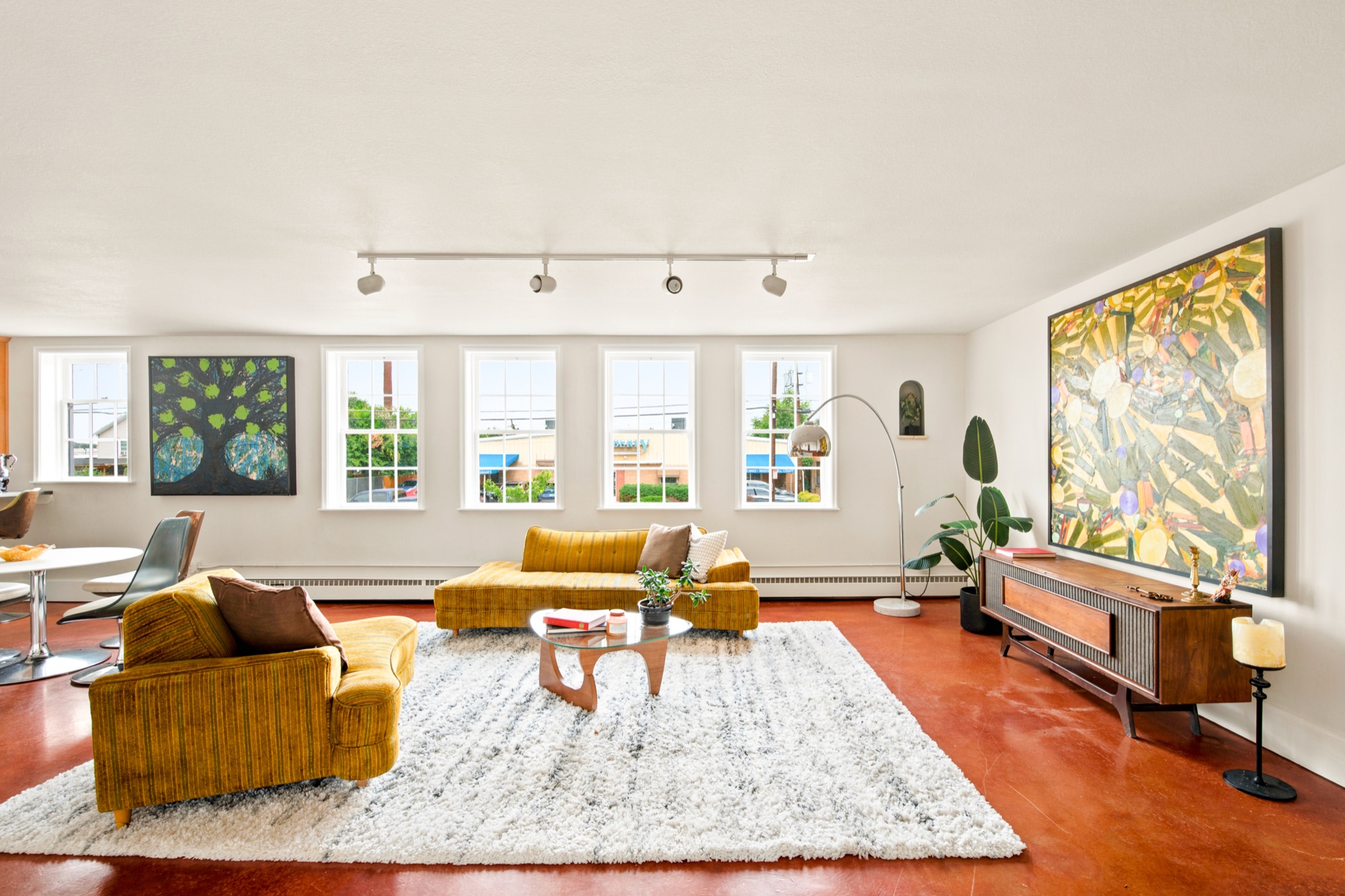 Unit 2A living room — mid-century furnishings and a wall of windows, The Nunnery, Denver